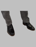 Model Wearing Black Medallion Toe Wingtip Oxford With A Suit 