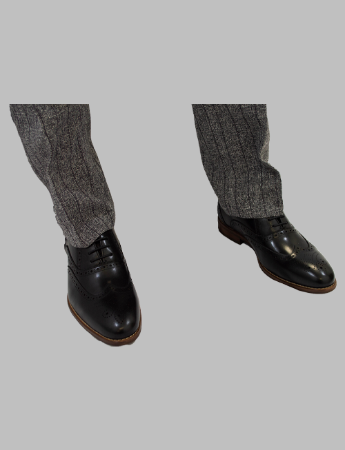 Model Wearing Black Medallion Toe Wingtip Oxford With A Suit 